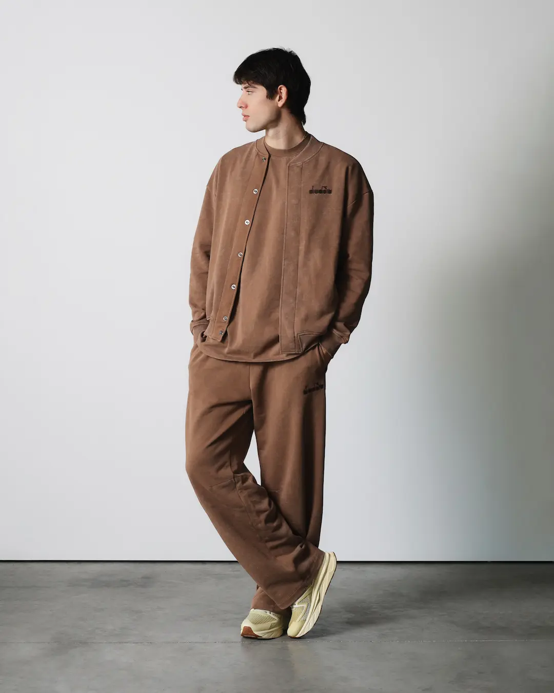 Model in a brown Diadora sweatshirt and trousers set