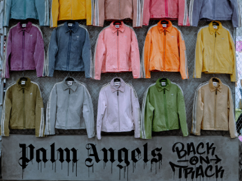 Wall of colourful Palm Angels track jackets above a "Back on Track" sign